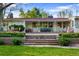 A home's charming patio features outdoor dining, plenty of seating, and a well-manicured lawn at 7900 Crest Dr, Lakewood, CO 80214