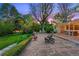 Expansive backyard with a stone patio, mature trees, and lush landscaping, offering a private retreat at 7900 Crest Dr, Lakewood, CO 80214