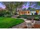 Well-manicured backyard featuring a stone patio, lush lawn, and cozy seating area perfect for outdoor relaxation at 7900 Crest Dr, Lakewood, CO 80214