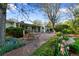 Beautiful backyard with a stone patio, lush garden beds, and outdoor seating area for relaxing at 7900 Crest Dr, Lakewood, CO 80214