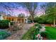 Outdoor patio with dining area and lovely landscaped garden beds in backyard at 7900 Crest Dr, Lakewood, CO 80214