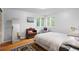 Bright bedroom with hardwood floors, light walls, and a large window at 7900 Crest Dr, Lakewood, CO 80214