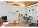 Cozy dining room featuring a stone fireplace, natural light, and modern décor at 7900 Crest Dr, Lakewood, CO 80214