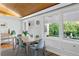 Well-lit dining room with wood floors, modern chairs, and a view to the backyard at 7900 Crest Dr, Lakewood, CO 80214