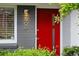 Eye-catching red front door with modern address numbers and stylish exterior light fixture at 7900 Crest Dr, Lakewood, CO 80214
