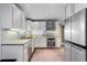 Bright kitchen featuring stainless steel appliances, a mosaic backsplash, and modern cabinetry at 7900 Crest Dr, Lakewood, CO 80214