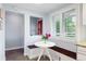 Kitchen nook with bench seating, a modern table, and a view to the outdoors at 7900 Crest Dr, Lakewood, CO 80214