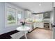 Bright kitchen featuring granite countertops, modern appliances, and a breakfast nook at 7900 Crest Dr, Lakewood, CO 80214