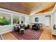 Inviting living room with hardwood floors, a wood ceiling, and large windows at 7900 Crest Dr, Lakewood, CO 80214