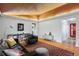 Open-concept living room showcasing a unique wood ceiling and hardwood floors at 7900 Crest Dr, Lakewood, CO 80214