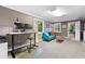 Functional office space with a desk, sofa, and access to the backyard at 7900 Crest Dr, Lakewood, CO 80214