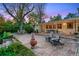 Large stone patio with comfortable seating and chiminea, ideal for outdoor gatherings and relaxation at 7900 Crest Dr, Lakewood, CO 80214
