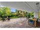 Covered patio with stone columns, outdoor seating, and dining area, perfect for entertaining guests at 7900 Crest Dr, Lakewood, CO 80214