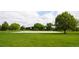 Outdoor basketball court surrounded by vibrant green lawns and mature trees on a sunny day at 7777 E 23Rd Ave # 1202, Denver, CO 80238
