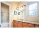 Bright bathroom featuring a marble countertop, wood cabinets, and a tiled shower-tub combo at 7777 E 23Rd Ave # 1202, Denver, CO 80238