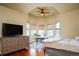 Bedroom features natural light with a work area, dresser, and spacious layout at 7777 E 23Rd Ave # 1202, Denver, CO 80238