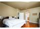 Spacious bedroom featuring a bed and arched doorway leading to an en-suite bathroom at 7777 E 23Rd Ave # 1202, Denver, CO 80238