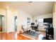 Cozy bedroom area with a comfortable chair, desk, and an exercise bike, blending relaxation and fitness at 7777 E 23Rd Ave # 1202, Denver, CO 80238