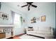 Bright bedroom featuring hardwood floors, white sofa, changing table, and decor at 7777 E 23Rd Ave # 1202, Denver, CO 80238