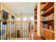 Hallway with hardwood floors and built-in bookshelves along the walls at 7777 E 23Rd Ave # 1202, Denver, CO 80238