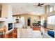 Open-concept living area with vaulted ceilings, fireplace, hardwood floors, and seamless flow to the dining and kitchen at 7777 E 23Rd Ave # 1202, Denver, CO 80238