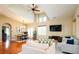 Bright, spacious living area with vaulted ceilings, hardwood floors, and contemporary furniture at 7777 E 23Rd Ave # 1202, Denver, CO 80238