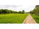 Expansive green park with walking path, mature trees, and a pedestrian bridge in the distance at 7777 E 23Rd Ave # 1202, Denver, CO 80238