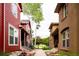A sidewalk in a townhouse community, lined with manicured landscaping and inviting front porches at 7777 E 23Rd Ave # 1202, Denver, CO 80238