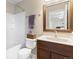 Well-lit bathroom with a shower-tub combination and a dark wood vanity at 7841 S Kalispell Cir, Englewood, CO 80112