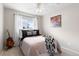 Comfortable bedroom with carpet, a ceiling fan, and natural light from the window at 7841 S Kalispell Cir, Englewood, CO 80112