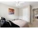 Bright bedroom with a ceiling fan, closet, and an adjacent room adding more space at 7841 S Kalispell Cir, Englewood, CO 80112