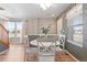 Inviting dining area featuring a round table, white chairs, and lots of natural light from the adjacent window at 7841 S Kalispell Cir, Englewood, CO 80112