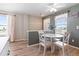 Charming dining area adjacent to the kitchen, featuring a round table, white chairs, and bright natural light at 7841 S Kalispell Cir, Englewood, CO 80112