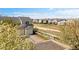 A row of townhomes stand along the green common area and walking path at 7841 S Kalispell Cir, Englewood, CO 80112