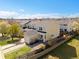 Inviting yellow townhome featuring a well-manicured lawn and charming white seating area, perfect for relaxing outdoors at 7841 S Kalispell Cir, Englewood, CO 80112