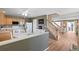 Open kitchen features wood cabinets, white appliances, and easy access to the staircase and living room at 7841 S Kalispell Cir, Englewood, CO 80112