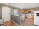 Bright kitchen featuring wood-style flooring, stainless steel appliances, and a cozy breakfast nook with a view at 7841 S Kalispell Cir, Englewood, CO 80112