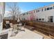 Back patio with a table and chairs, and a grill perfect for outdoor entertaining at 7841 S Kalispell Cir, Englewood, CO 80112