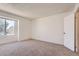 Simple bedroom featuring a window and neutral-colored carpet at 10762 E Exposition Ave # 336, Aurora, CO 80012