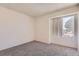 This bedroom has neutral carpet, a window and light-colored walls at 10762 E Exposition Ave # 336, Aurora, CO 80012