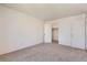 This bedroom has neutral carpet and an open closet at 10762 E Exposition Ave # 336, Aurora, CO 80012