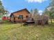 Home's backyard featuring a wooden deck with a hot tub, perfect for outdoor relaxation at 7754 Swaps Trl, Evergreen, CO 80439
