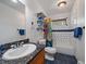 Bright bathroom featuring modern fixtures, white tile, and colorful shower curtain at 7754 Swaps Trl, Evergreen, CO 80439