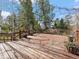 Large wood deck with railings and potted plants offers an outdoor living space at 7754 Swaps Trl, Evergreen, CO 80439