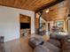 Spacious living area featuring a wood-burning stove, open floor plan and natural light at 7754 Swaps Trl, Evergreen, CO 80439