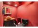 Unique powder room with red walls, decorative sink, and gilded mirror at 4871 S Dunkirk Way, Centennial, CO 80015