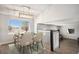 Bright dining area with modern lighting, neutral walls, and lots of natural light at 4871 S Dunkirk Way, Centennial, CO 80015