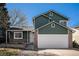 Two story home featuring a two car garage, green siding, brick accents, and manicured front yard at 4871 S Dunkirk Way, Centennial, CO 80015