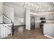 Open kitchen concept featuring stainless steel appliances, breakfast bar, and an adjoining living area at 4871 S Dunkirk Way, Centennial, CO 80015
