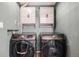 Laundry room featuring matching front load washer and dryer and built in storage cabinets at 4871 S Dunkirk Way, Centennial, CO 80015